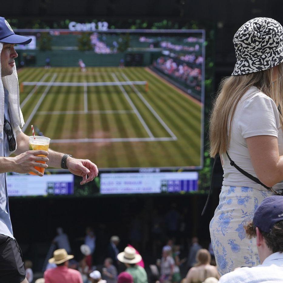 Photos of Wimbledon fans and players struggling to stay cool in record-breaking heat